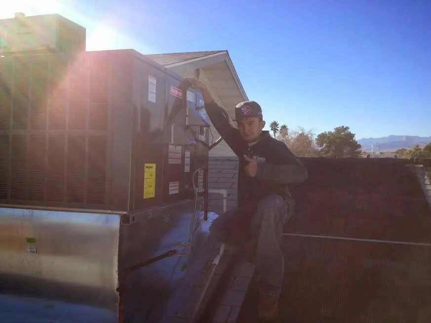 HVAC technician performing HVAC Inspection on a rooftop unit in Mount Pleasant
